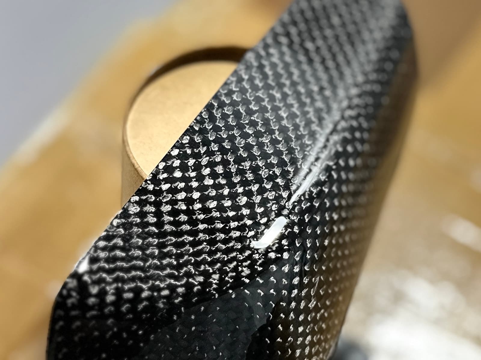 Clear coated carbon fibre part after trimming and finishing
